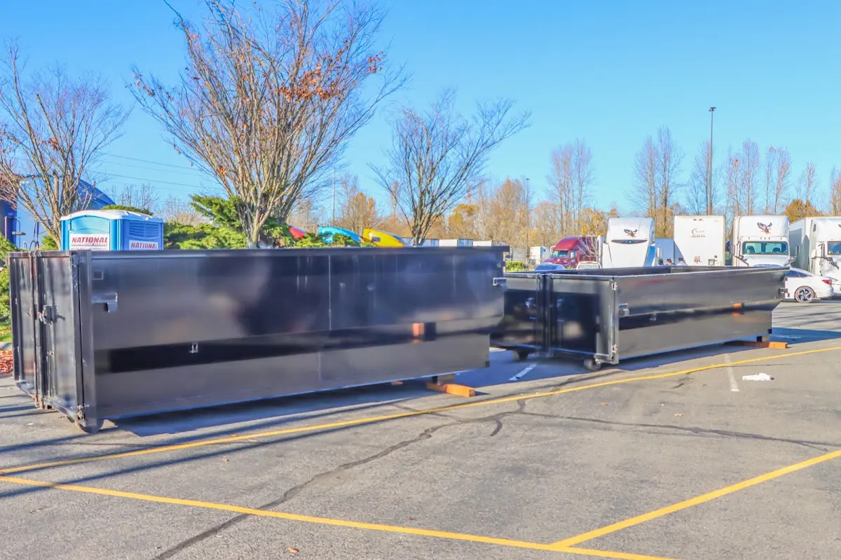 Professional dumpster rental service with roll-off container on residential driveway in Willmar